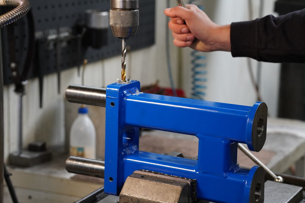 Bohrer bohrt durch ein großes Metallteil